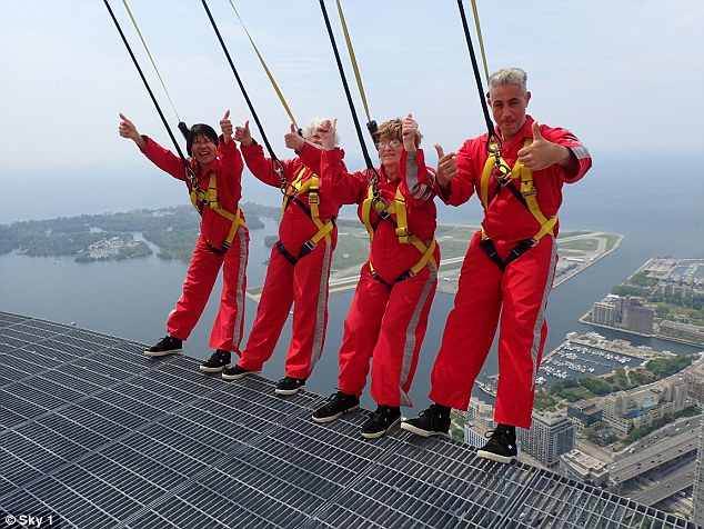 Baz, right, with the daring pensioners hang over the edge of the tower