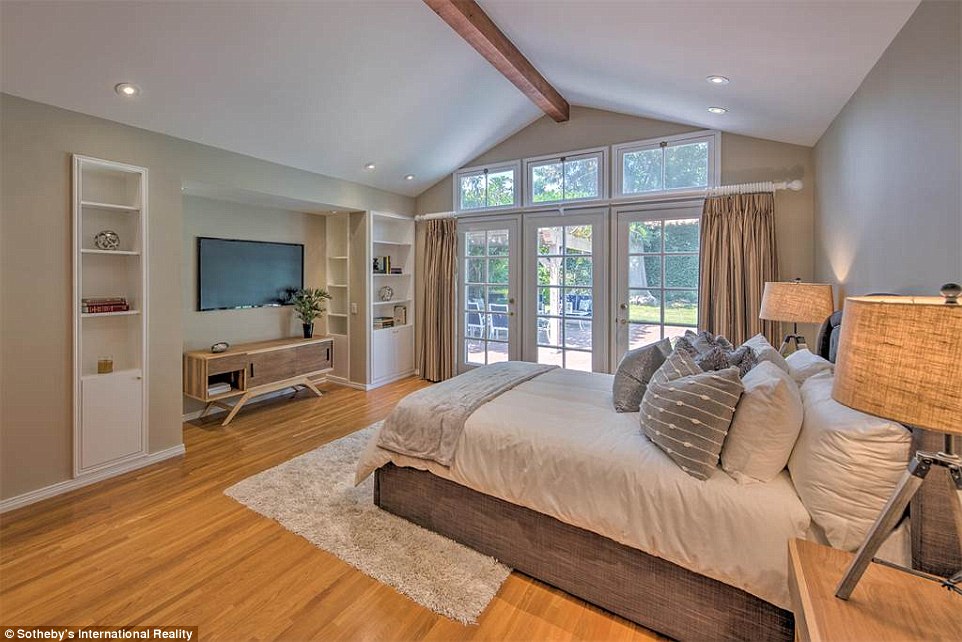 Lots of light: The master bedroom boasts a vaulted ceiling and large French doors leading to the outdoor patio
