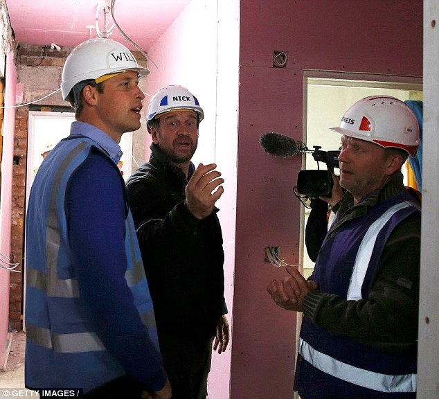 The Duke of Cambridge speaks to Nick Knowles while helping to renovate homes for ex-service personnel as part of the BBC documentary DIY SOS last year
