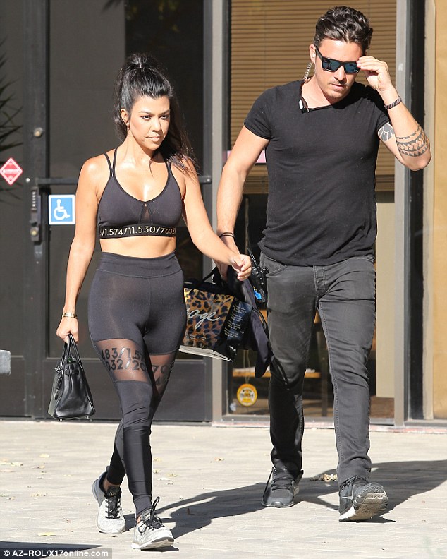 Protection: The Keeping Up With The Kardashians star left the building with her hunky bodyguard