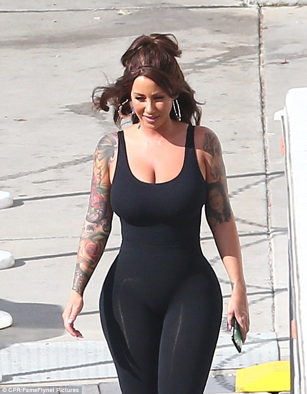 New look: She usually sports a platinum blonde buzz cut, but the reality star decided to try out a curly brown wig for the show