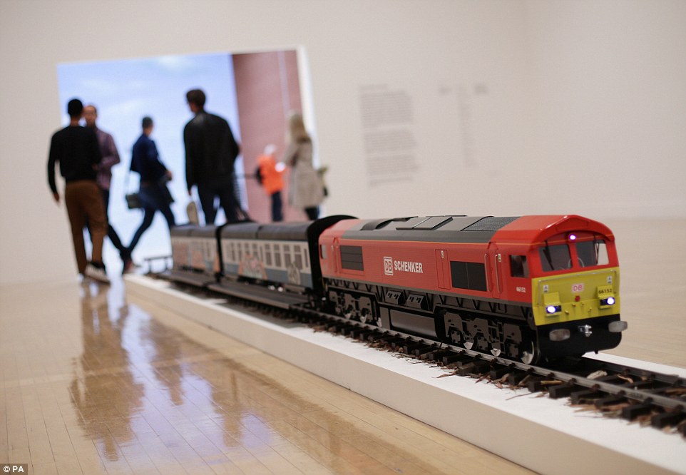 A model of a train entitled The New Media Express in a Temporary Siding (Baby Wants To Ride) 2016 has been installed by artist Josephine Pryde
